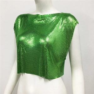 Detailed view of shimmering green metal mesh fabric texture on a cropped sleeveless top