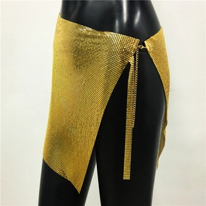 Detail showing gold metal sequins and mesh structure on a party body chain skirt