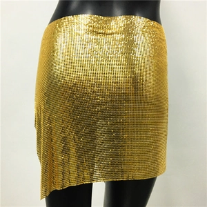 Detailed view of shimmering gold metal mesh texture on a mini party skirt