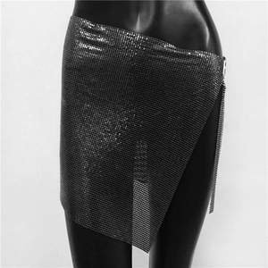 Detailed view of gunmetal sequin mesh skirt with asymmetric hem and chain link detail