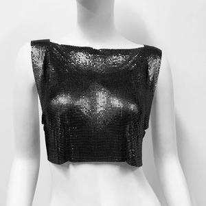 Detail of black metallic sequin mesh top featuring a punk style cropped fit and reflective finish