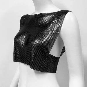 Macro detail of black metal sequins linked by rings on a sexy punk style crop top vest