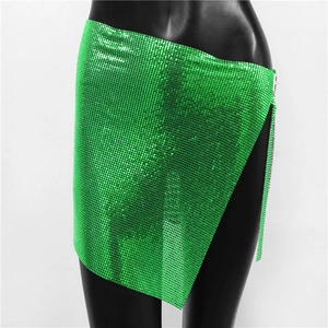 Detail of emerald green metal mesh mini skirt with shiny sequins for parties