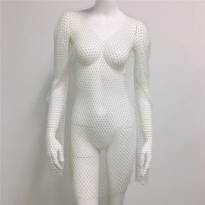 Close-up detail of white mesh dress with sparkling rhinestones and elegant V-neck design