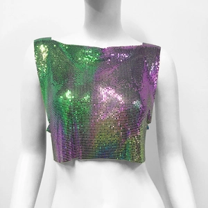 Macro detail of gradient metal mesh sequins on a cropped party top with shiny finish