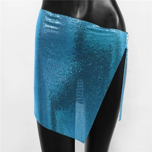 Detail of blue sequin mini skirt featuring asymmetric cut and side slit for party wear