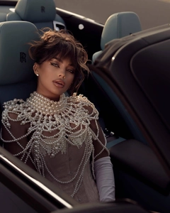 Detailed close-up of luxurious white pearl body chain with fringe and stand collar