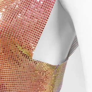 Detailed macro view of the metallic sequin mesh fabric on a rose gold halter top