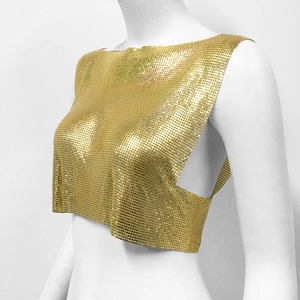 Detail shot of shimmering golden chainmail sequins on a cropped metallic party vest top