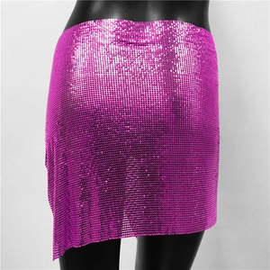 Close-up of metallic rose pink sequin chainmail mini skirt with asymmetrical hemline