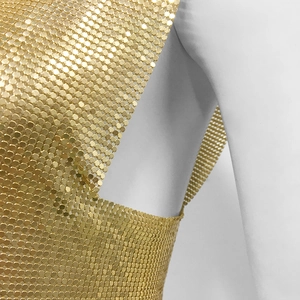 Detail of shimmering gold metal mesh texture and sequin chainmail craftsmanship