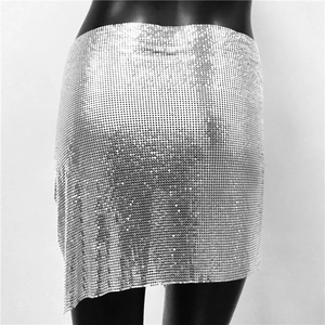 Detailed macro view of silver metal sequins and mesh texture on a sexy party mini skirt