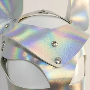 Close-up of holographic leather rabbit mask with silver studs and sparkling rhinestones