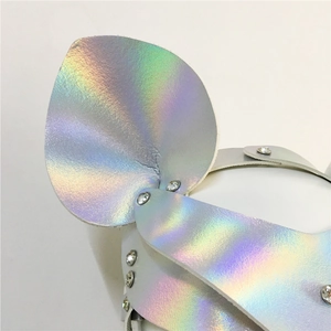 Macro detail of holographic leather material with rhinestones on party face mask