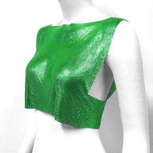 Detail of emerald green metallic mesh crop top showing shiny chain sequins and side cut-outs