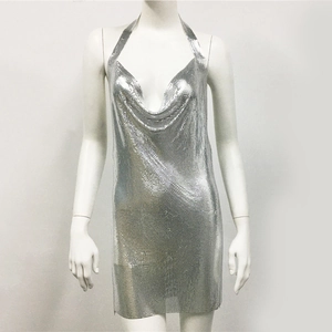 Close-up of shiny silver metal mesh texture on a deep V-neck halter party dress