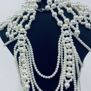 Detail of luxury multilayered pearl body chain with silver lobster clasp on mannequin