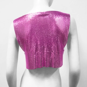 Close-up of fuchsia metal sequin mesh texture on a backless party crop top vest
