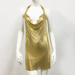 Detail of shimmering gold metallic sequin halter dress with open back for party wear