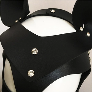 Close-up of black leather mask with round ears and rhinestones for cosplay