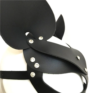 Close-up of black leather masquerade mask with animal ears and rhinestone embellishments