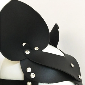 Detail of black leather cat ear mask featuring intricate silver rhinestones and layered texture