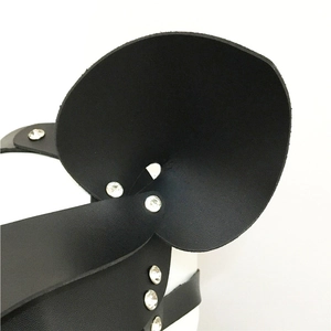 Close-up of black leather mask details with sparkling silver rhinestone rivet studs