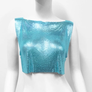 Macro detail of turquoise metallic sequins and mesh texture on a sexy crop top