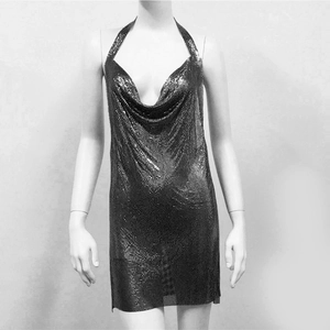 Detailed view of silver chainmail mesh texture and deep V-neck on a mini party dress
