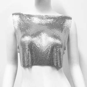 Detailed close-up of metallic silver sequin crop top with chainmail texture on mannequin