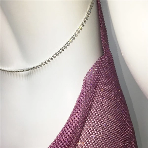 Detail of purple rhinestone mesh fabric and double-row crystal chain straps on dress