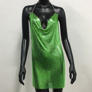 Detail of green metal mesh fabric and drape neck design on a sexy party dress