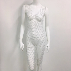 Close-up of white mesh rhinestone dress featuring sparkling crystals and sheer net fabric