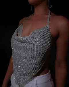 Macro view of sparkly silver rhinestone halter top with detailed metallic mesh texture