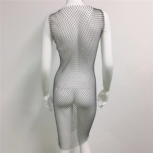 Detail view of black rhinestone fishnet dress with mesh knit pattern and crystal accents