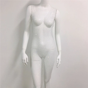 Close-up of sparkling crystals on white mesh fabric of a semi-transparent dress