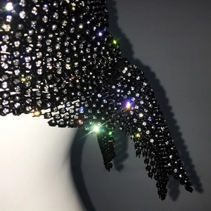 Macro shot of glittering rhinestones on a black mesh headscarf for party accessories
