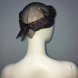 Close-up of sparkling colorful rhinestones on black mesh headpiece with tie-knot detail