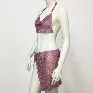 Detail of pink rhinestone halter top and side slit mini skirt with sparkling mesh texture