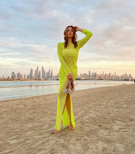 Detail of neon yellow mesh dress with high side slit and rhinestone shoe accessory