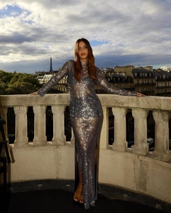 Close-up of sparkling rhinestone mesh fabric with high side slit on an elegant maxi dress
