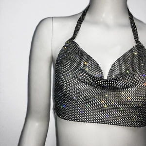 Detail shot of shimmering rhinestone halter top with black fabric and cowl neck