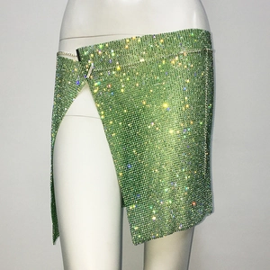 Detail of sparkling lime green rhinestone mini skirt with asymmetrical high slit wrap design