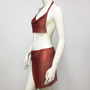 Detailed macro view of red rhinestone halter top and side slit mini skirt with metal chains