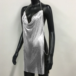 Detail of sexy silver metal mesh sequin dress with side chain links and open back