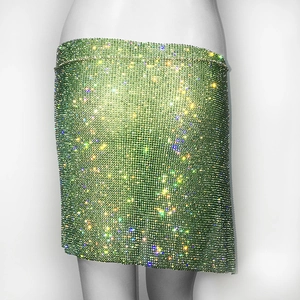 Détail macro du tissu en maille de strass verts sur une mini-jupe sexy de boîte de nuit