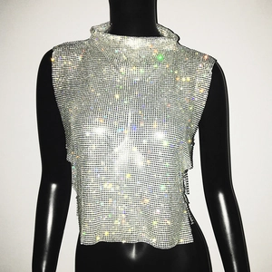 Detailed view of silver rhinestone mesh top with high neck and side slit party design