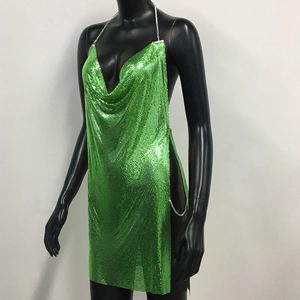 Detailed view of lime green sequin mesh texture and metallic chain link on slit dress