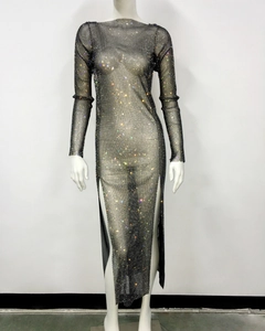 Detail of sheer black mesh dress with shimmering rhinestones and a side split