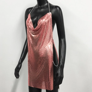 Detail of rose gold metal mesh dress showing the halter neck chain and cowl neck design